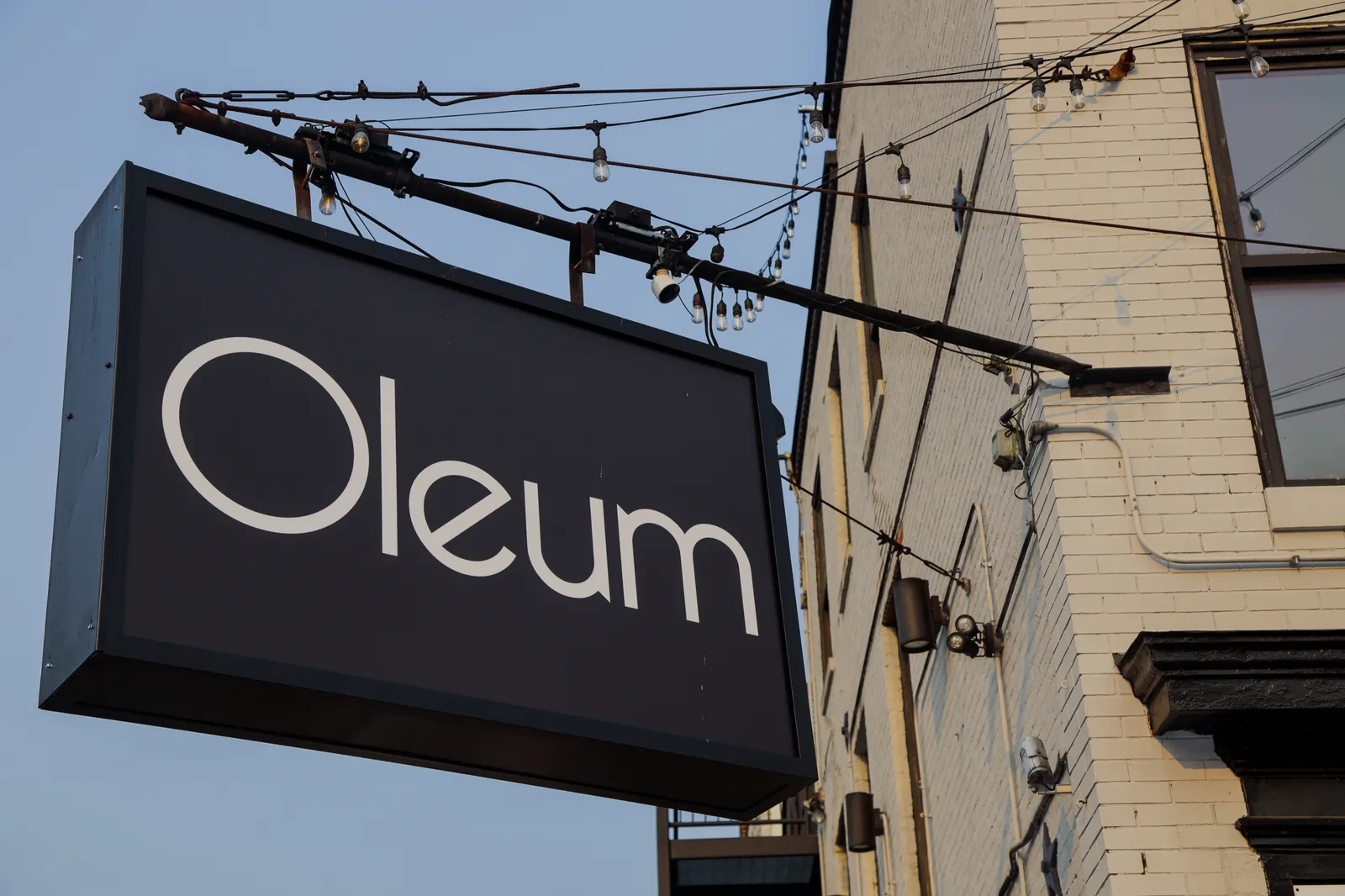 Oleum Vegan Kitchen — exterior hanging sign