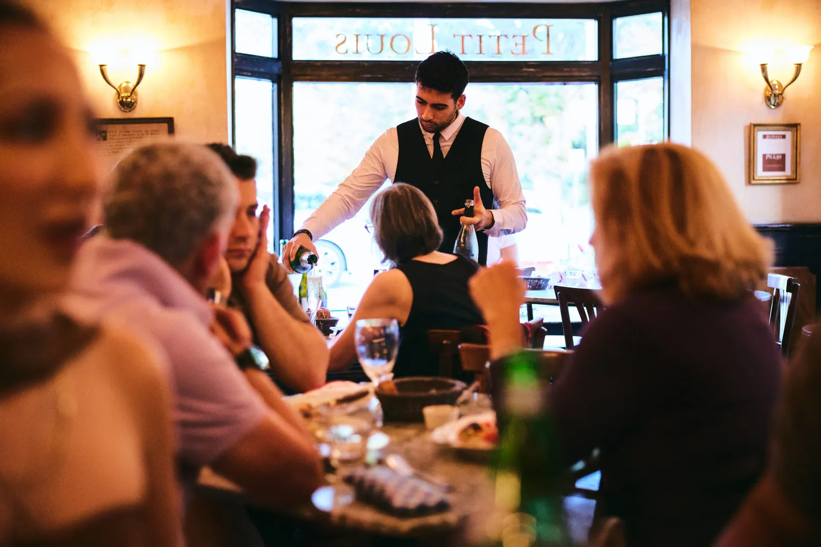 Petit Louis Bistro — dining room (window lettering)
