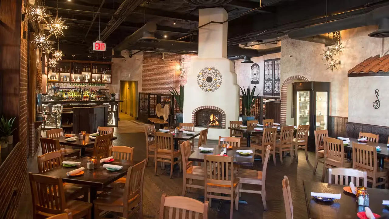 Dining room with a fireplace and bar at La Palapa Grill & Cantina in Ellicott City